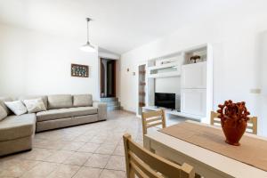a living room with a couch and a table at Segni Holiday Home in Carloforte