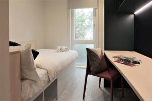 a bedroom with a bed and a table and a window at ALTIDO Affordable Dublin Parkgate - Adults only in Dublin