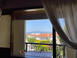 a room with a window with a view of a balcony at Maviev Otel in Cesme