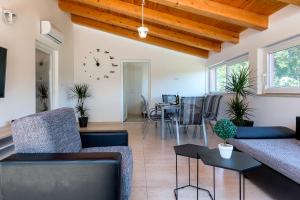 a living room with couches and a dining room at House Bumbiste 1703 in Banjole