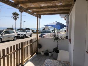 a balcony with a view of a parking lot with cars at Casita de Bolonia in Bolonia
