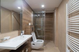 a bathroom with a toilet and a sink and a shower at Penzion Hradisko in Rožnov pod Radhoštěm