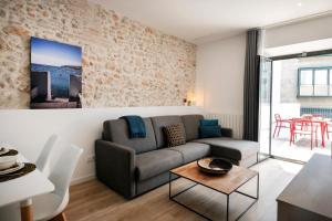 a living room with a couch and a table at NC Apartments Rambla 32 in Figueres
