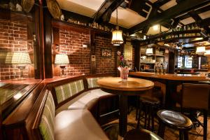 a bar with a table and chairs in a room at Hotel Fabritz in Essen
