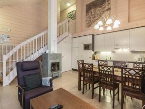 a kitchen and dining room with a table and a fireplace at Holiday Home Sointuilevi 2 d 13 by Interhome in Levi