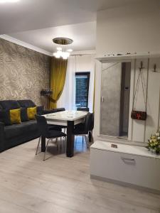 - un salon avec une table et un canapé dans l'établissement Apartament Ozon Poiana Brasov, à Poiana Brasov