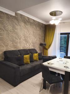 a living room with a couch and a table at Apartament Ozon Poiana Brasov in Poiana Brasov
