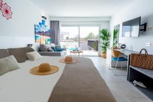 a living room with a table with two hats on it at Hotel Taimar in Costa Calma