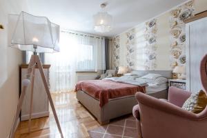- une chambre avec un lit, une lampe et une chaise dans l'établissement Willa Major, à Dziwnów