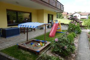 a backyard with a playground with a slide at Ferienwohnung Katzer in Mossautal