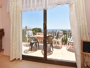 a room with a door open to a balcony with a table and chairs at Apartment Regina by Interhome in Torredembarra +28 photos