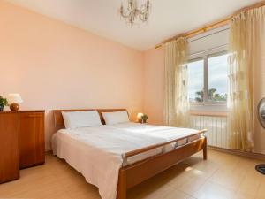 a bedroom with a large bed and a window at Apartment Regina by Interhome in Torredembarra