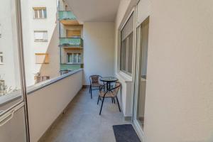 a balcony with two chairs and a table at Apartman Danube lux in Novi Sad