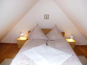 a bedroom with a bed with pillows and two lamps at Holiday Home Kranich by Interhome in Troja