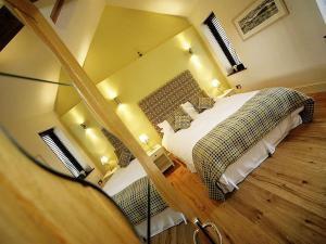 a hotel room with two beds and a mirror at Blas Gwyr in Llangennith