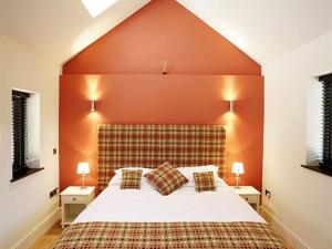 a bedroom with a white bed and white walls at Blas Gwyr in Llangennith