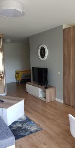 a living room with a flat screen tv on a wall at Palanga-Smilgu. g. in Palanga