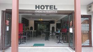 a hotel with tables and chairs in the doorway at Cheng Ho Hotel in Melaka