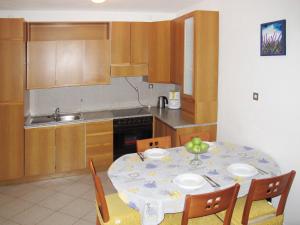 a kitchen with a table with chairs and a table and a table at Apartment Giuliano-3 by Interhome in Frata
