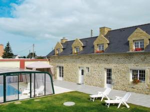 a house with a patio and a swimming pool at Holiday Home Villa Mor-Eol - PNR211 by Interhome in Plounéour-Trez