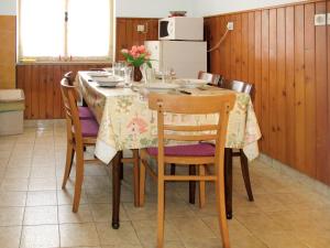 a kitchen with a table with chairs and a refrigerator at Holiday Home Mirjana - PRC420 by Interhome in Vržnaveri