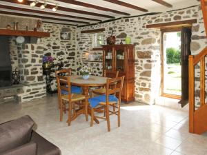 a dining room with a wooden table and chairs at Holiday Home La Chevalerie by Interhome in Sourdeval-les-Bois