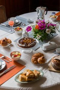 a table topped with plates of food and flowers at Le Clos Des Ormeaux in Vineuil