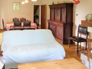 a bedroom with a bed and a table and chairs at Holiday Home Cherte by Interhome in Uza