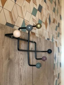 a chandelier above a wooden door with a tile wall at Székely Fogadó Self Check In Hotel Guesthouse in Tunyogmatolcs