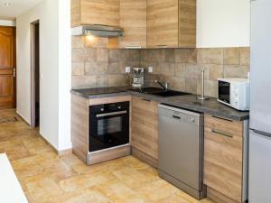 a kitchen with a sink and a stove at Apartment A Suara di Mare by Interhome in Ghisonaccia