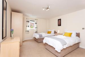 a bedroom with two beds and a window at Oakstays Newcastle Gem in Newcastle upon Tyne