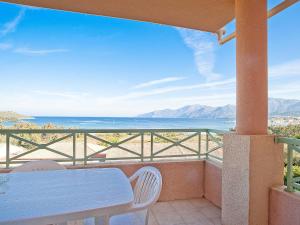 a balcony with a table and a view of the ocean at Apartment Suarella-2 by Interhome in Saint-Florent