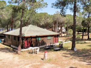 a small house in a field with trees at Holiday Home Tramariccia-3 by Interhome in Calvi +12 photos