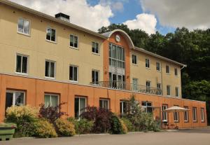 a large building with a balcony on top of it at Hotell Munkeröd in Stenungsund