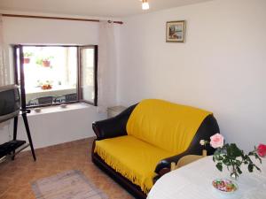a yellow couch in a living room with a window at Holiday Home Luiza - PRC162 by Interhome in Vabriga