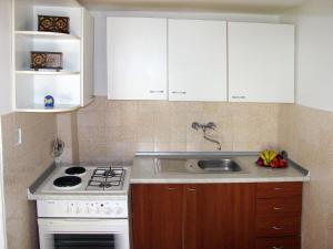a kitchen with a sink and a stove and cabinets at Holiday Home Luiza - PRC162 by Interhome in Vabriga