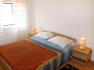 a bedroom with a bed with two lamps on two tables at Holiday Home Luiza - PRC162 by Interhome in Vabriga
