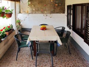 a table with chairs and fruit on a patio at Holiday Home Luiza - PRC162 by Interhome in Vabriga