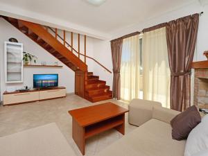 a living room with a couch and a tv at Holiday Home Petrovic by Interhome in Kaštelir +15 photos