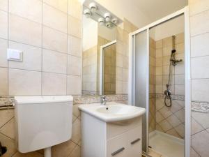 a bathroom with a toilet and a sink and a shower at Holiday Home Petrovic by Interhome in Kaštelir