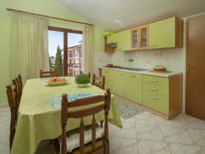 a kitchen with a table and a dining room at Apartment Jukić - KST138 by Interhome in Kaštelir