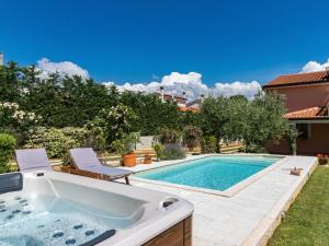 a swimming pool with a hot tub in a yard at Holiday Home Petar - KST253 by Interhome in Tar