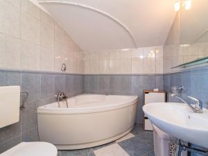 a bathroom with a tub and a sink and a toilet at Holiday Home Petar - KST253 by Interhome in Tar