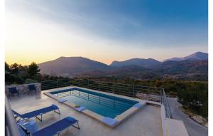 a swimming pool on the roof of a house with mountains at Matušić Guest House in Dubrovnik