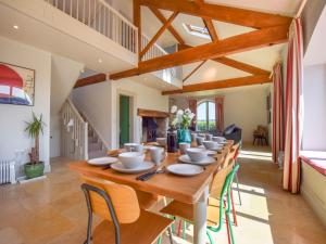 a large dining room with a long table and chairs at Oldbury Barn in Cheltenham