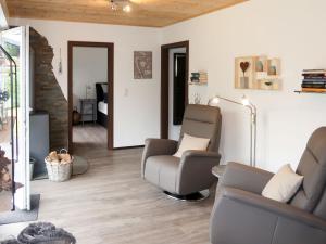a living room with two chairs and a couch at Holiday Home Caro by Interhome in Kirburg