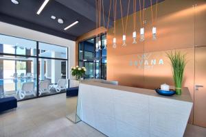 a lobby with a reception desk in a building at Savana Resort Mielno in Mielno