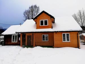 a house covered in snow at Dom - nad Potokiem in Lutowiska
