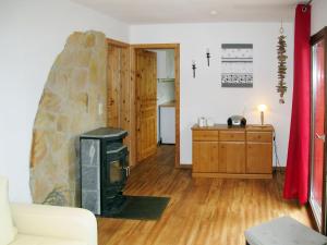 a living room with a fireplace and a stove at Holiday Home Waldhäuser-1 by Interhome in Himmelpfort