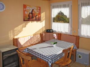 a dining room table with a checkered table cloth on it at Holiday Home Am Walde-2 by Interhome in Dobbertin